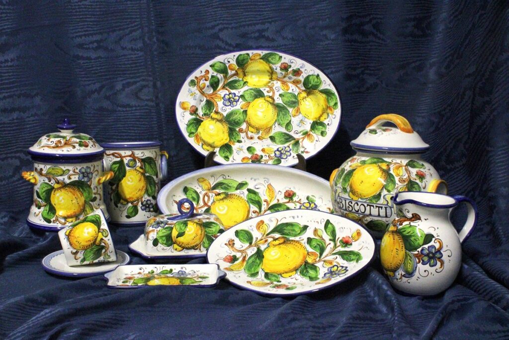 some items of the collection Limoni and flowers ceramics Borgioli, handmade ceramics made and decorated by hand ; there are a jar, trays, a butter dish and many other objects.