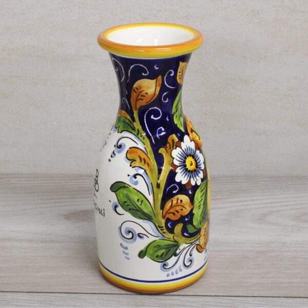 Italian Ceramic Carafe 0,5 liter, handmade and painted for wine, water and soft drinks. Side view, white flower on blue. The pattern's name is : Lemon on blue background.